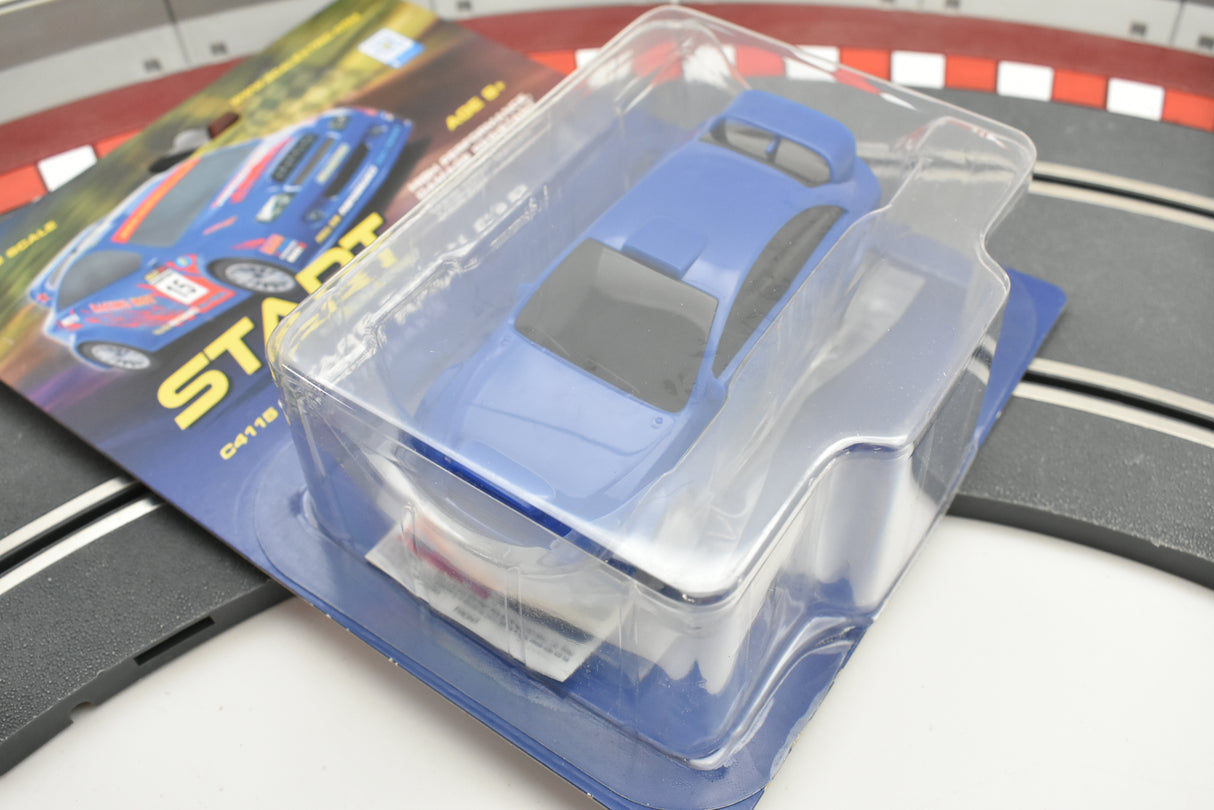 Blue race car in clear plastic packaging on a track section for Scalextric C4115