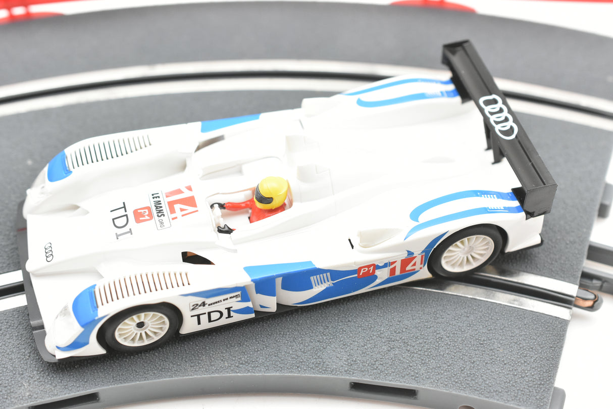 White and blue scale model of an Audi R10 TDI race car on a track for SCX A10300X3U0