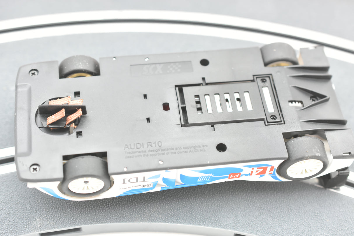Black slot car model of an Audi R10 with visible details for SCX A10300X3U0