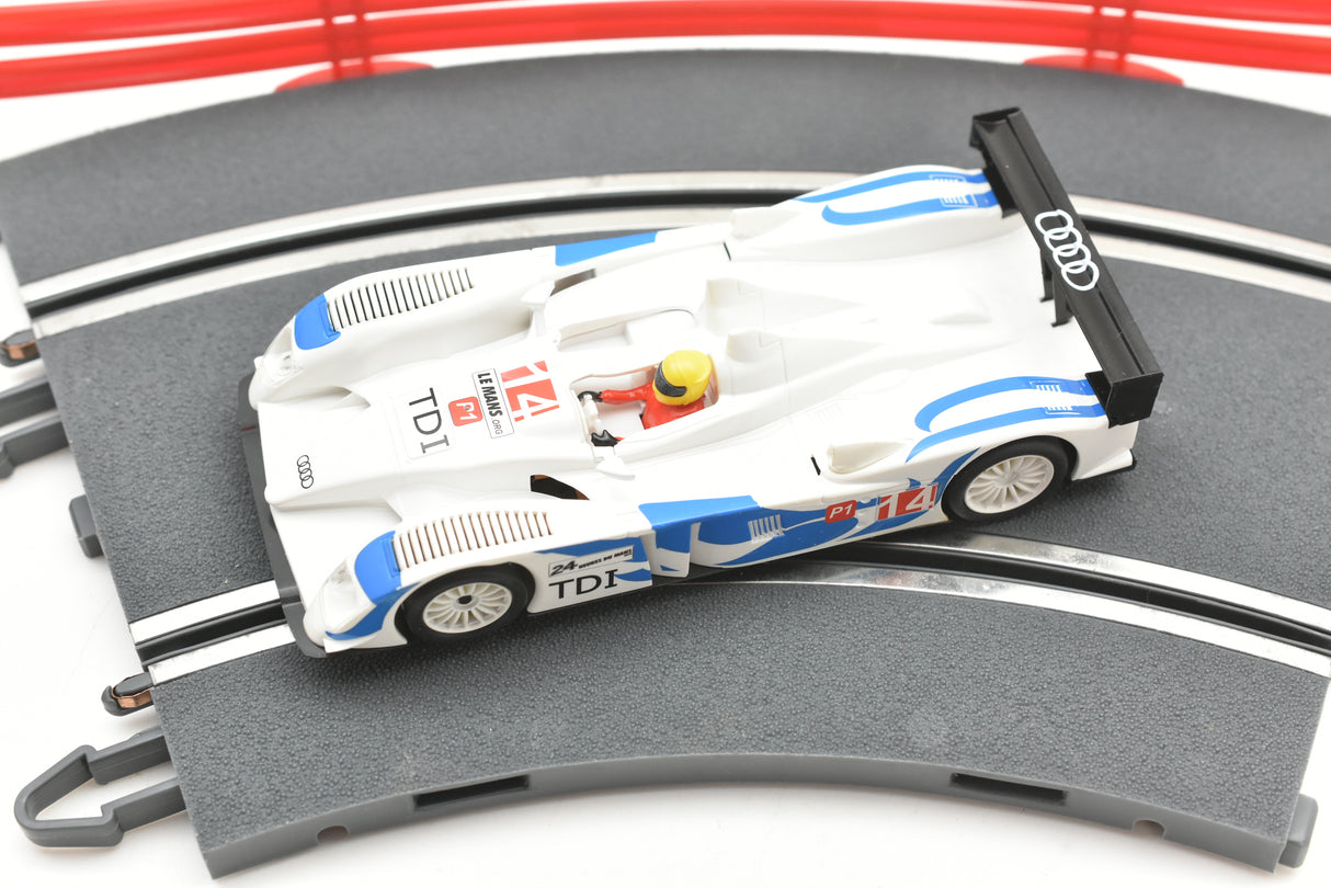 White and blue Audi R10 slot car on a track section for SCX A10300X3U0