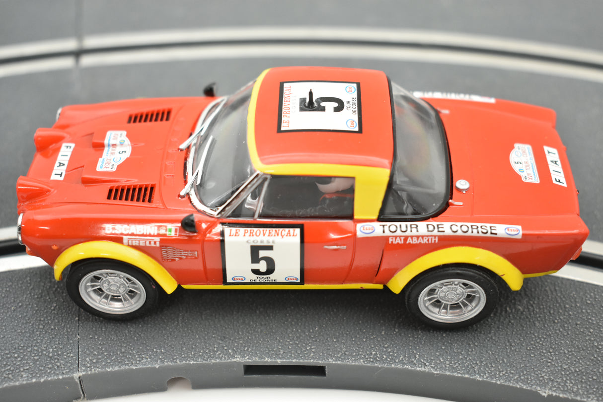 Red Fiat Abarth slot car racer on track for SCX A10220X3U0