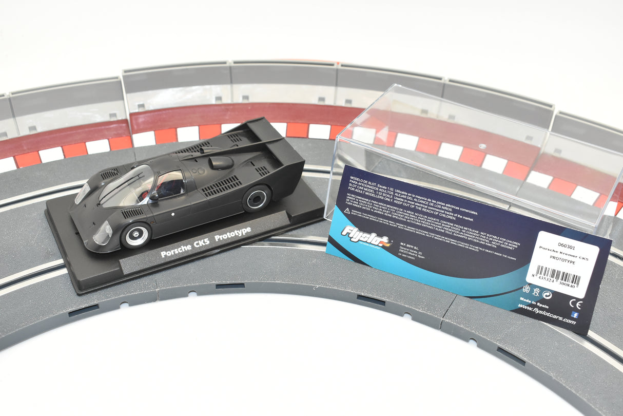 Black race car model on a curved slot track section for Fly Slot 060301