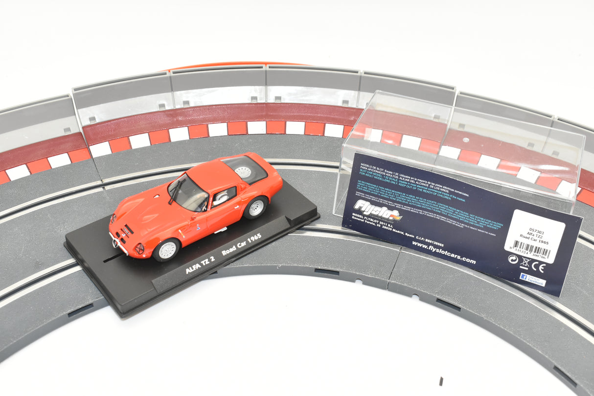 Red 1965 Alfa TZ 2 race car on a slot car track for Fly Slot 057303