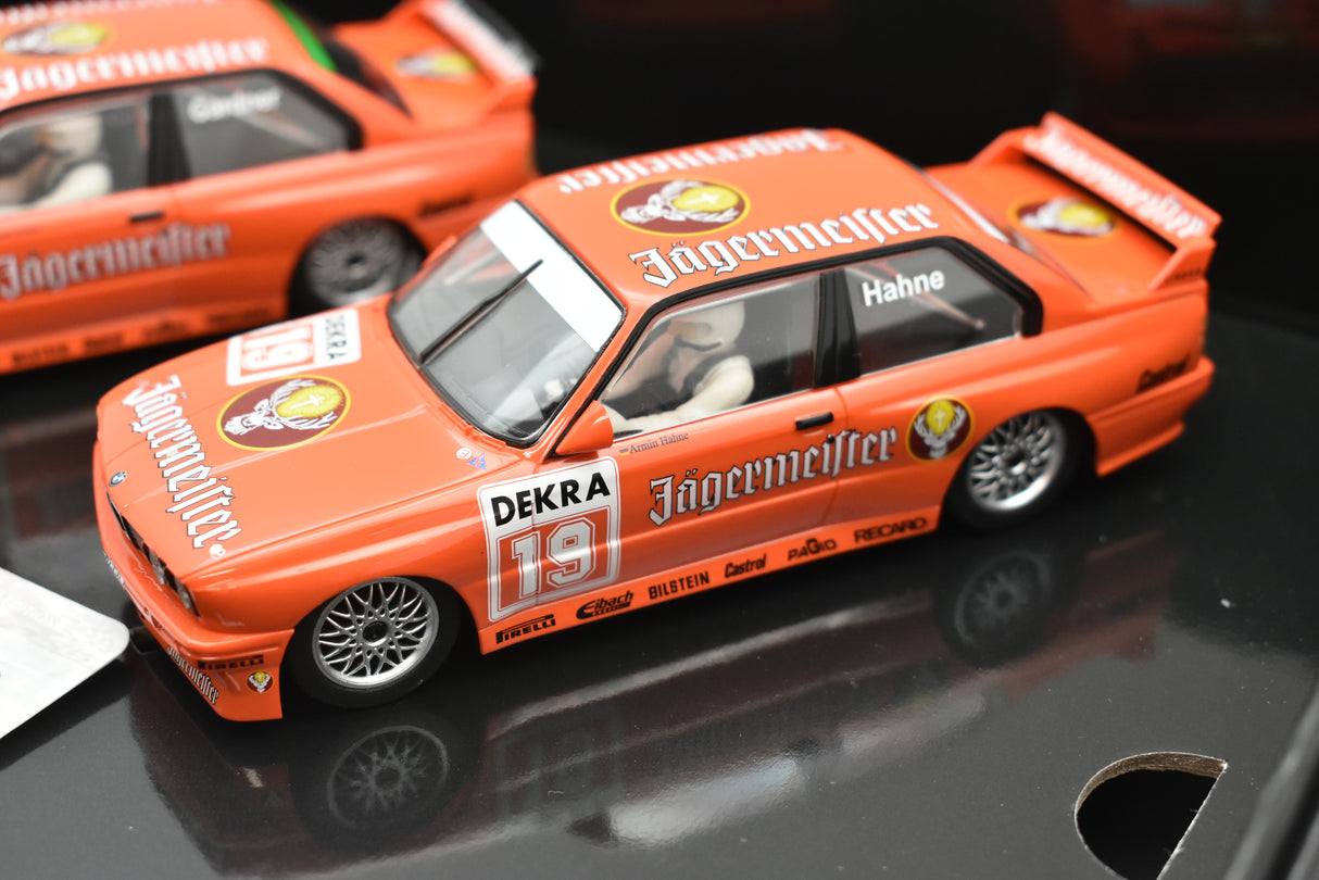 Orange slot car of a BMW E30 M3 race car for Scalextric C4110A