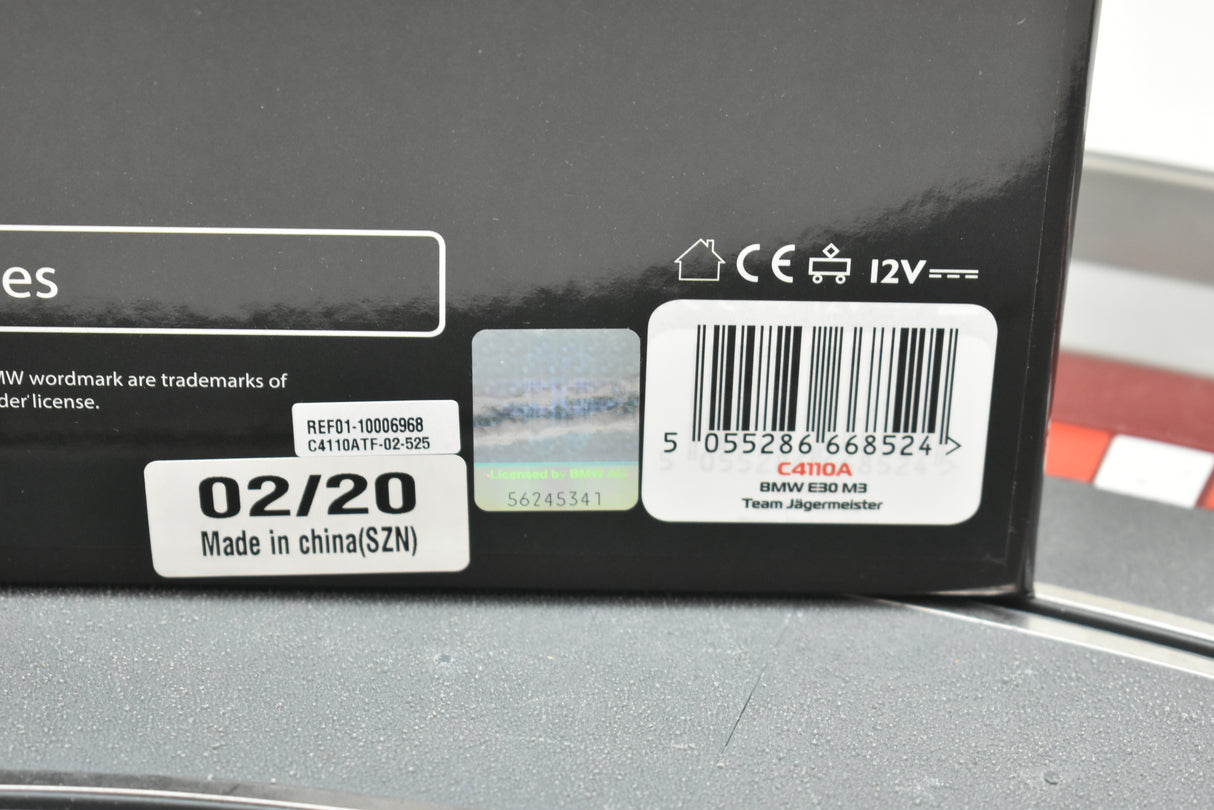 Product box showing model details for BMW E30 M3, Team Jägermeister for Scalextric C4110A