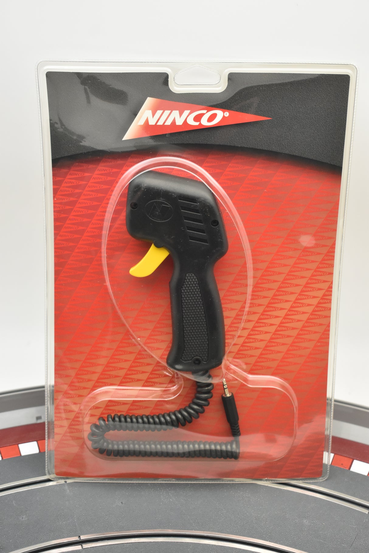 Hand throttle for model train, black with yellow accent, packaged for Ninco 10302