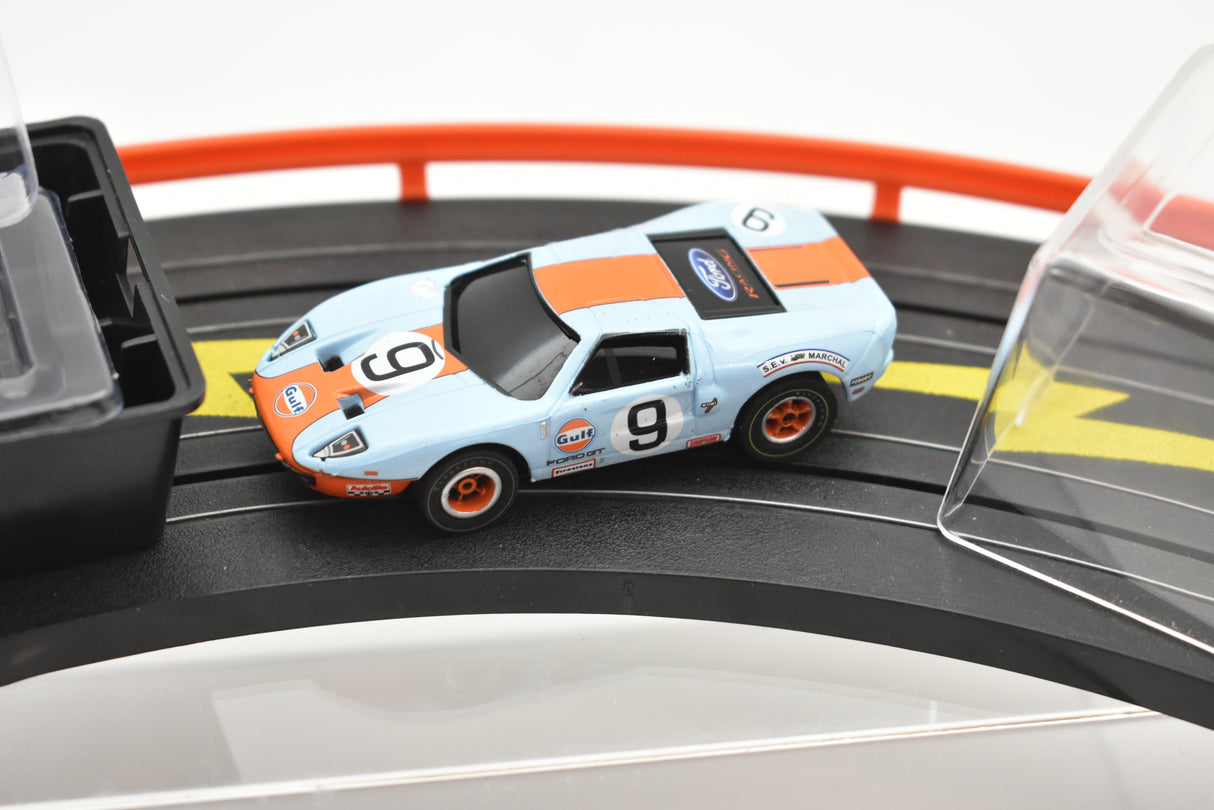 Blue and orange Gulf Ford GT race car on a track for Auto World SC0006