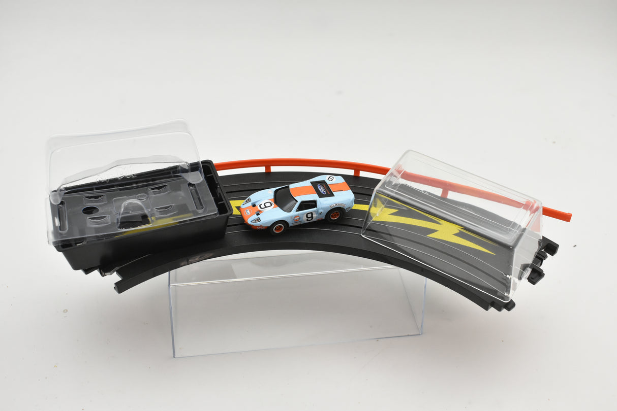 Slot car Ford GT race car on a black and yellow track set for Auto World SC0006