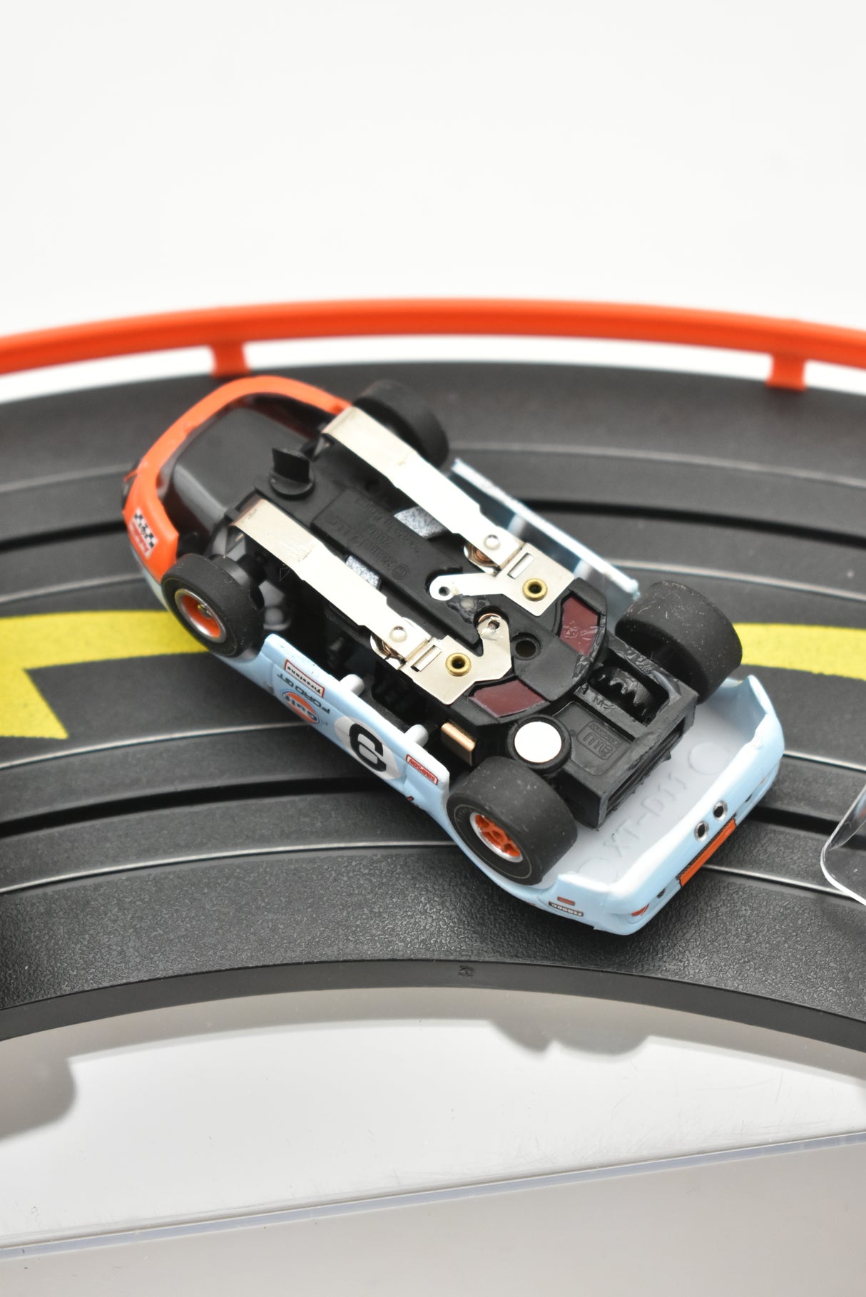 Blue and black slot car race car on a track section for Auto World SC0006