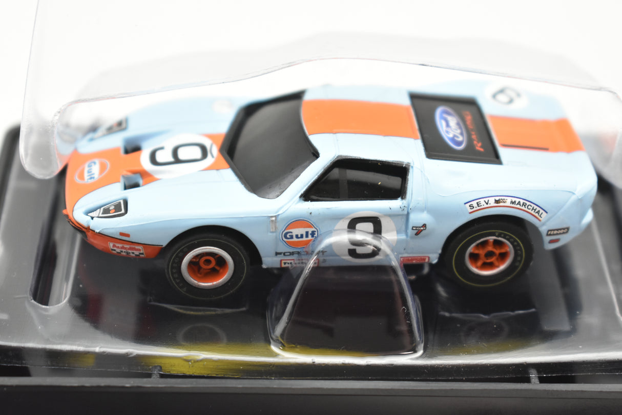 Blue and orange slot car, Gulf Ford GT, displayed in clear plastic case for Auto World SC0006