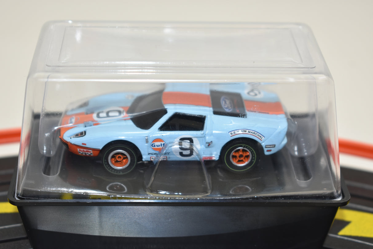 Blue and orange Gulf Ford GT slot car in clear plastic case for Auto World SC0006, front view