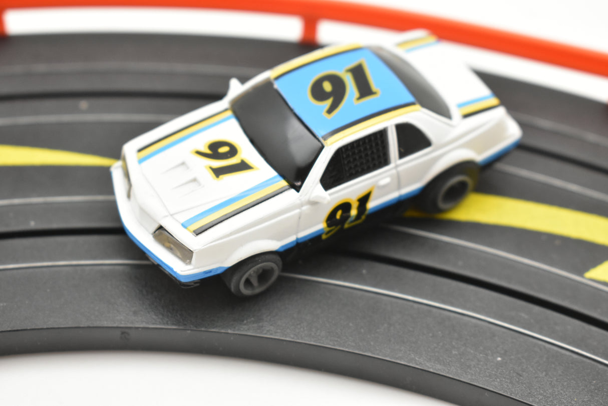 White and blue NASCAR race car on a track for Life-Like 13016B