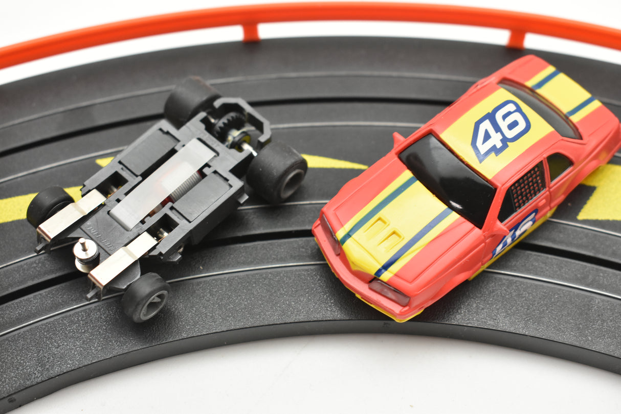 Red and yellow race car toy with number 46 on a track for Life-Like 13017B