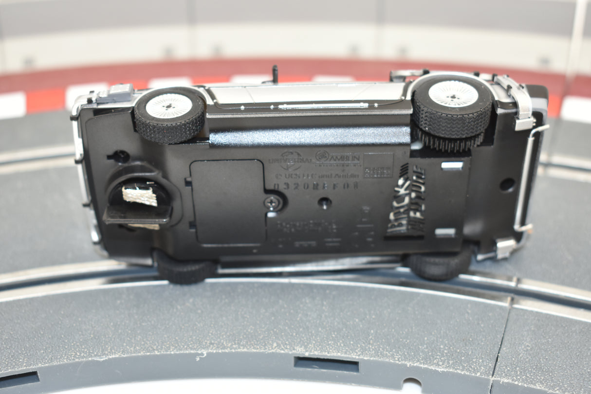 Black model car replica on a track surface for Scalextric C4117