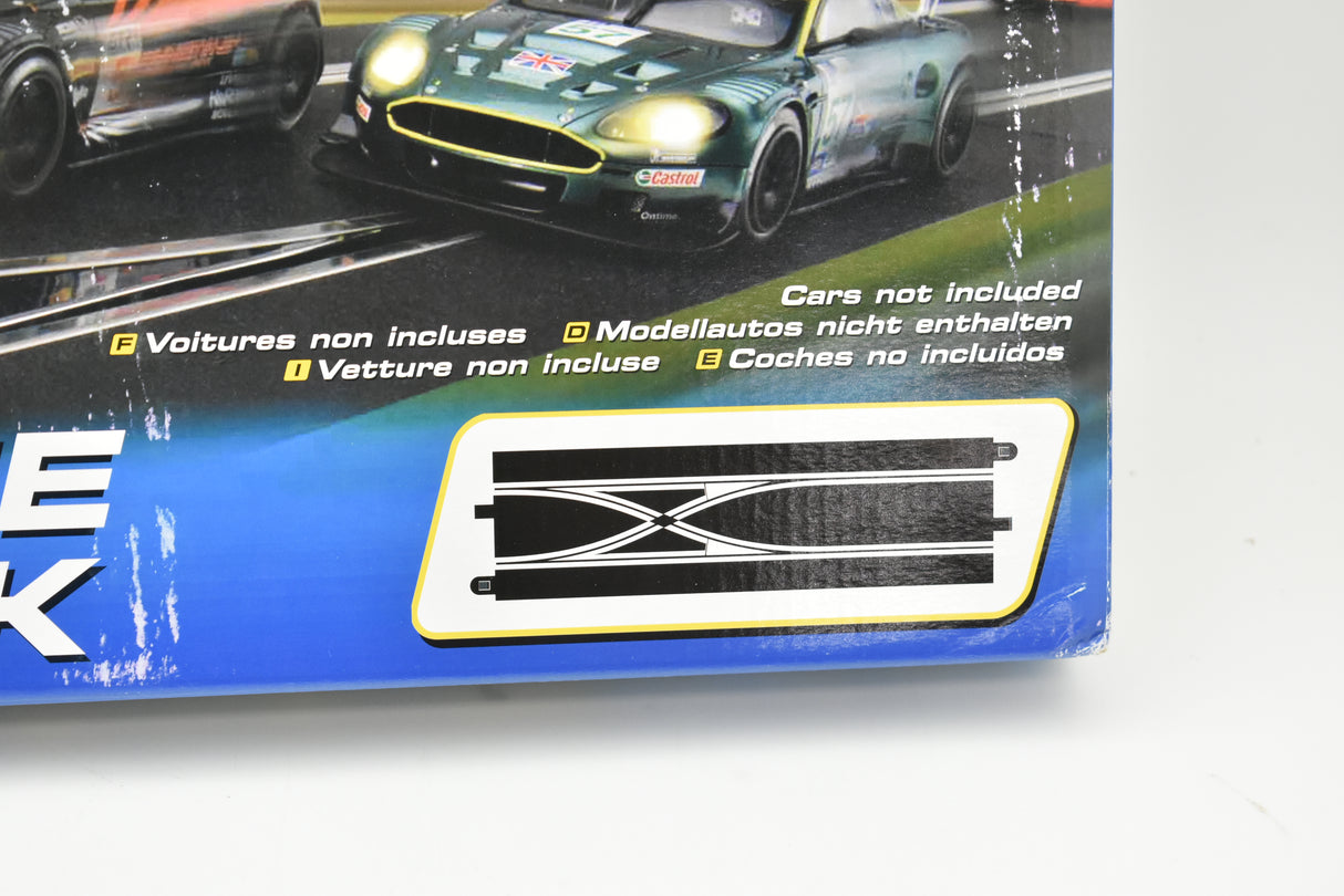 Race track set with cars, showing a straight lane change section for Scalextric C7036