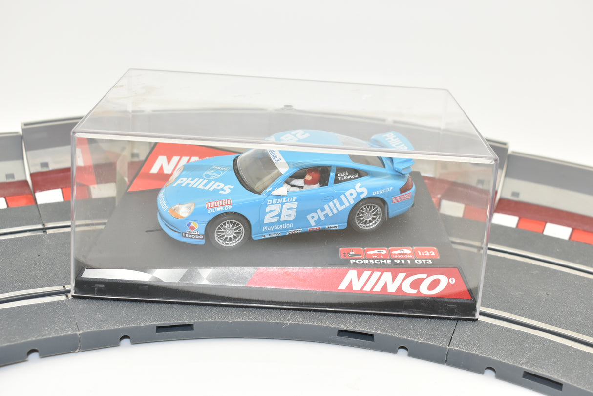 Blue Porsche GT3 race car in clear case on track section for Ninco 50242