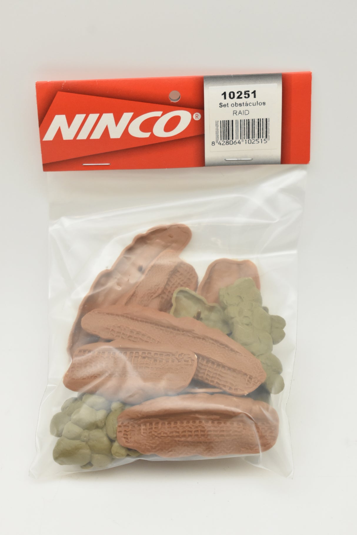 Assortment of brown and green plastic off-road obstacles in a clear bag for Ninco 10251, rear view
