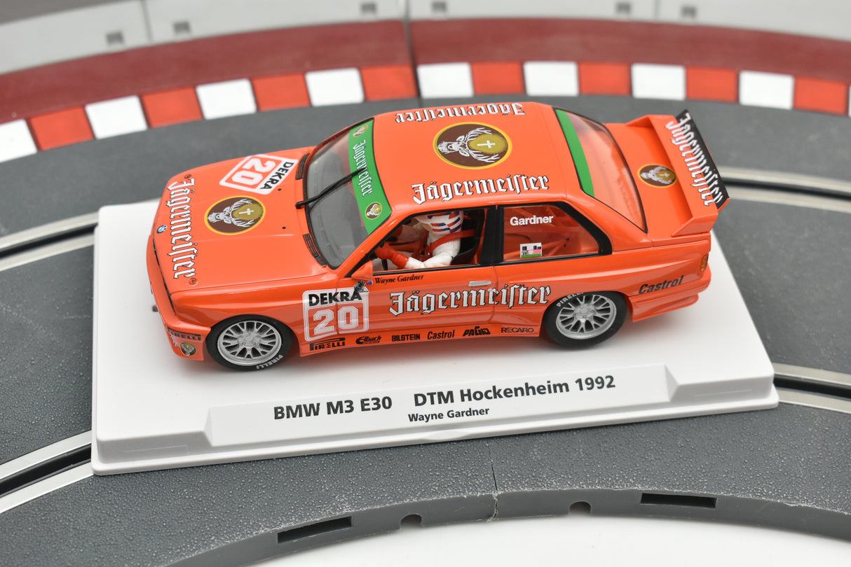 Orange BMW M3 E30 race car model on a display base for Fly Car Biker’s In Car 01