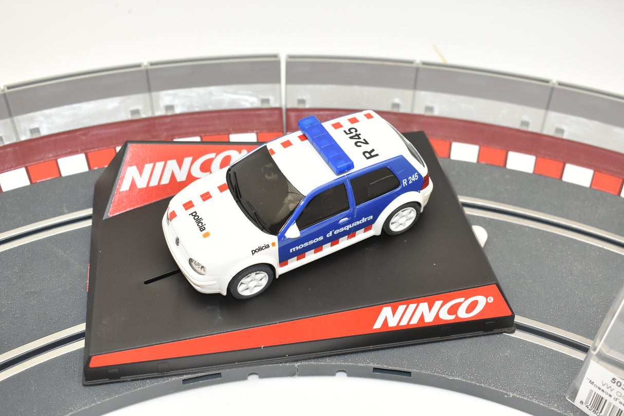 White VW Golf toy car with blue stripes, displayed on a track base for Ninco 50320