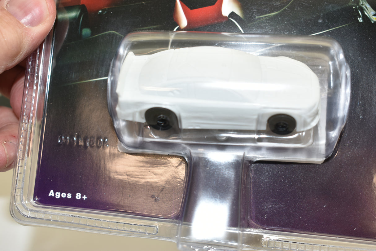 White slot car in clear plastic blister packaging for ages 8+ for AFX/Racemasters 21025