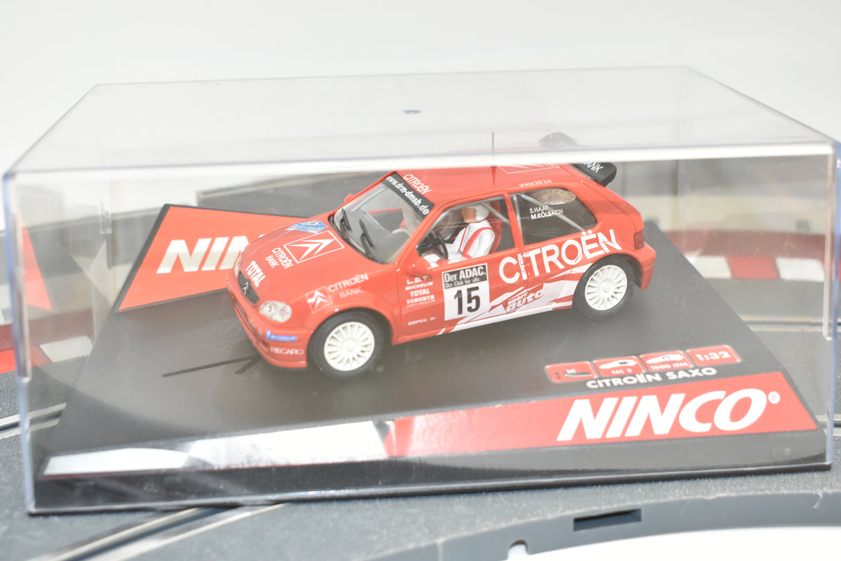Red slot car of a Citroen Saxo race car on a display base for Ninco 50284
