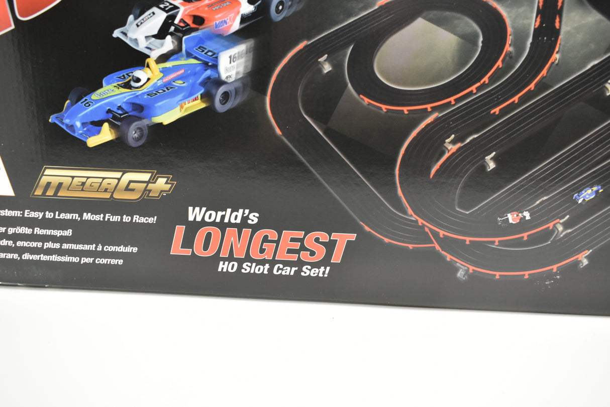 Blue and white race cars on a winding black and orange track set for AFX/Racemasters 22020