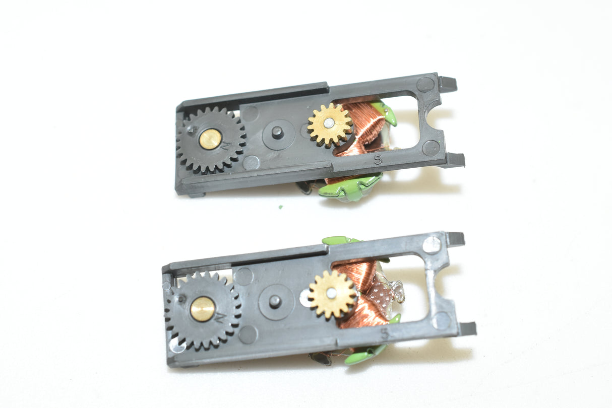 Two black metal top plate assemblies with gears and springs for Aurora AFX 1750-061