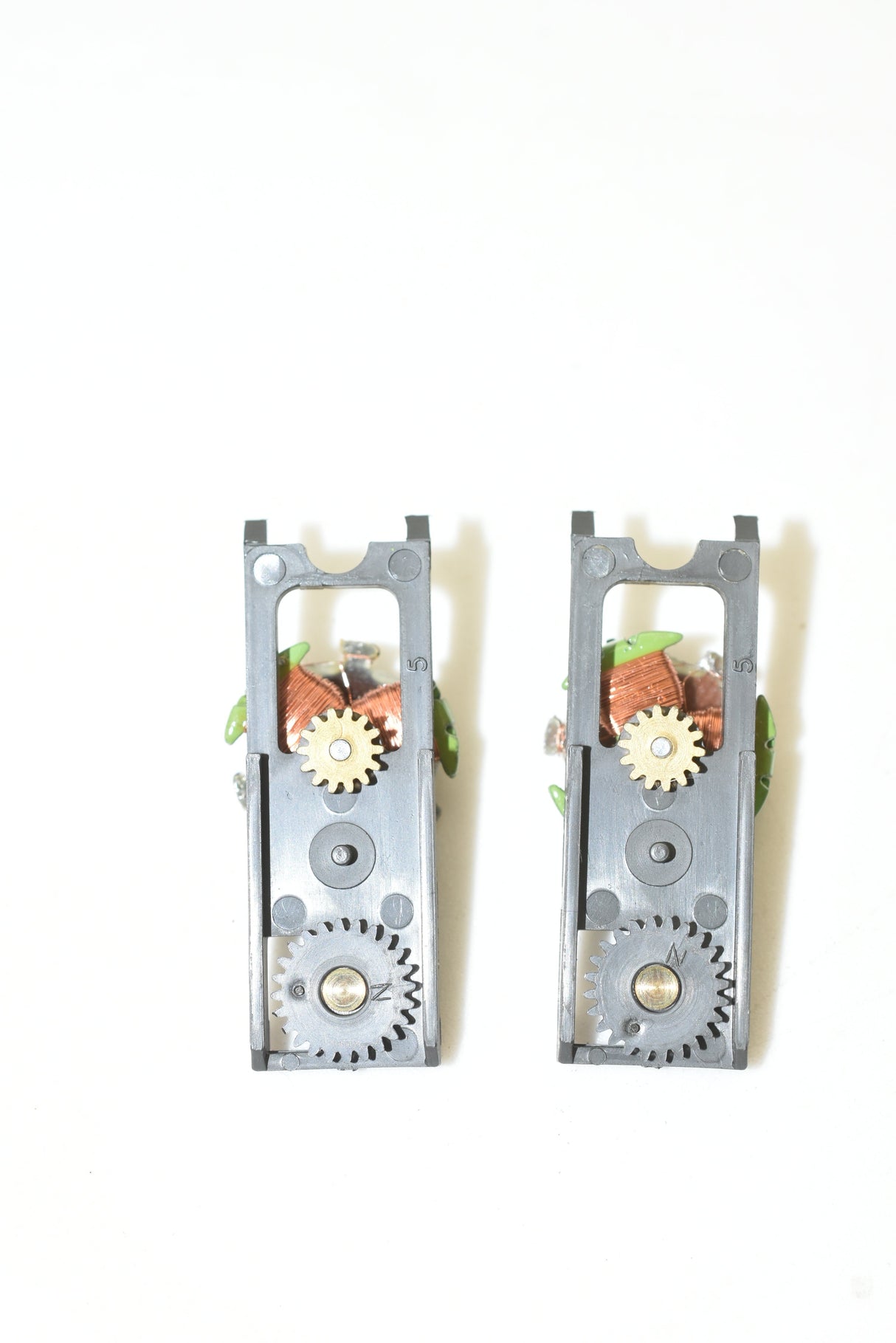 Two metal green top plate assemblies with visible gears and axles for Aurora AFX 1750-061