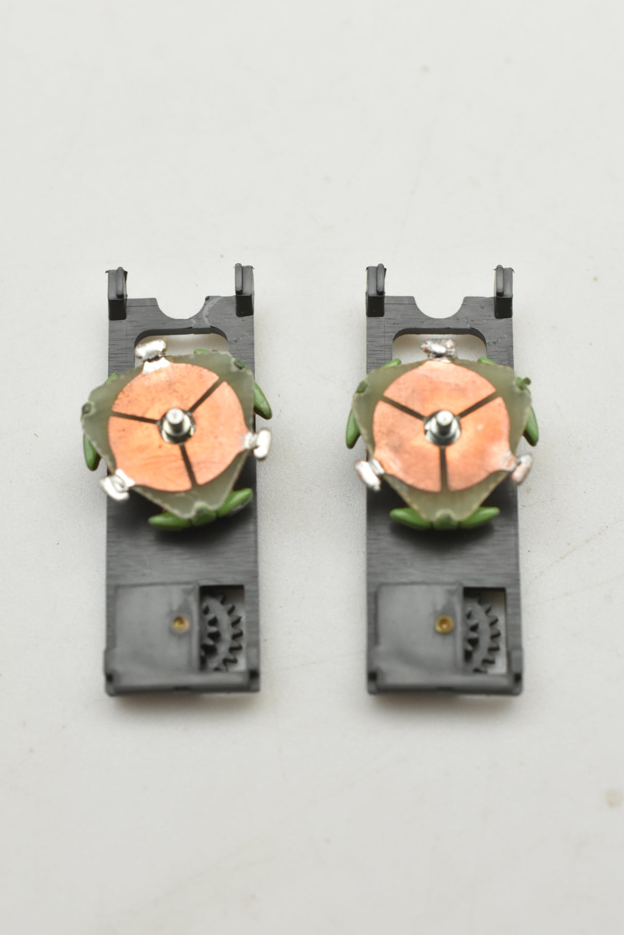 Two green and orange top plate assemblies for a model train for Aurora AFX 1750-061