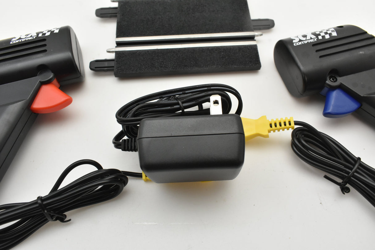 Power tool kit with chargers and cords laid out on a white surface for SCX Compact SC-01.050
