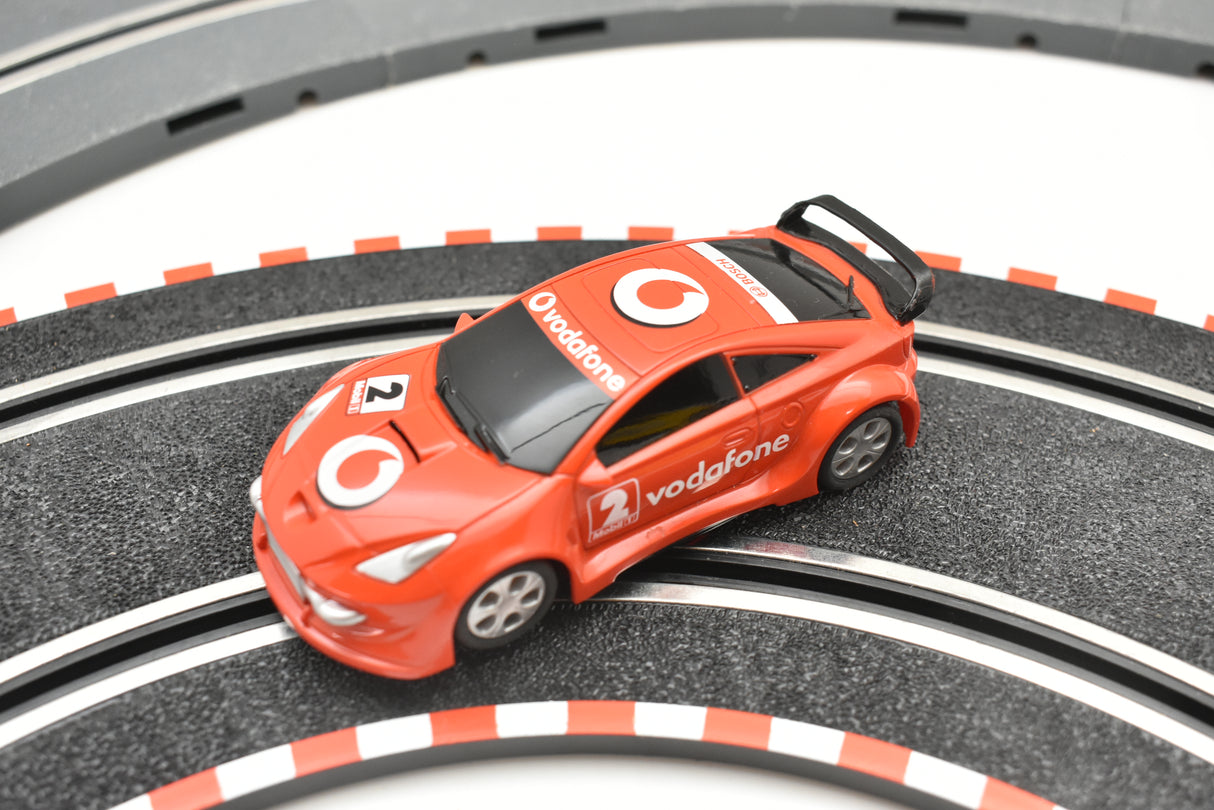 Red toy race car on a black and white track for SCX Compact C10183X300