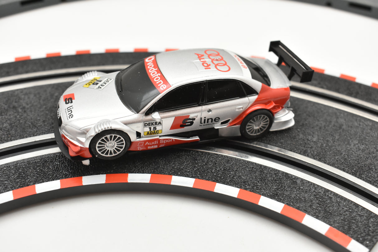 Slot car of a silver Audi A4 race car on a track for SCX Compact C10184X300