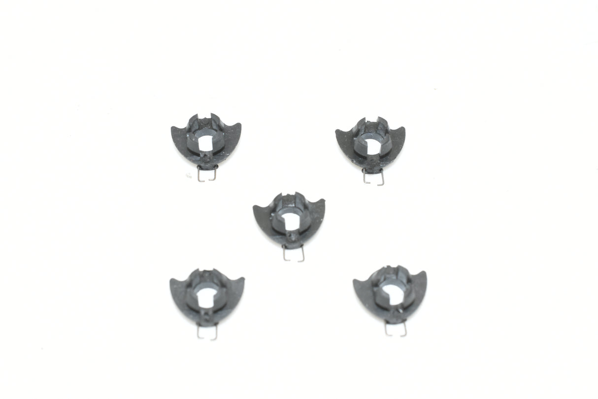 Five small, black, spring-like metal components for SCX ARS SD01699