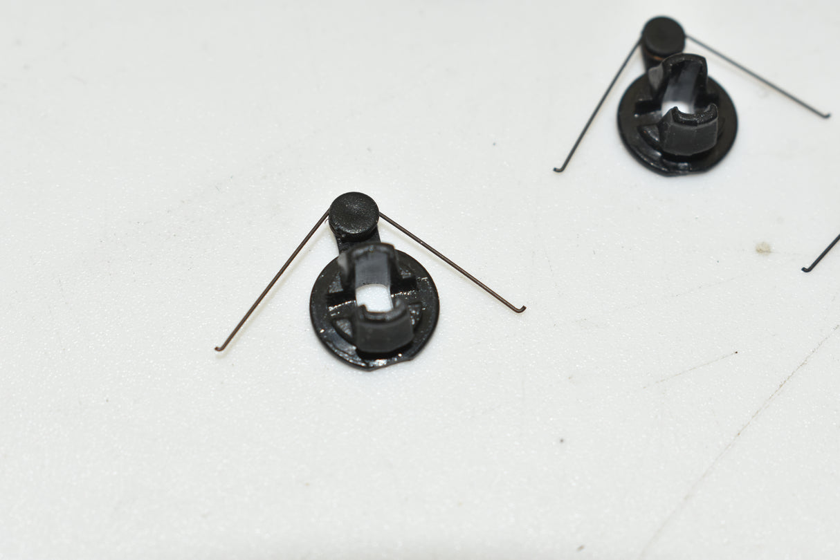 Two automatic return springs with thin metal wires attached for SCX ARS AD01442