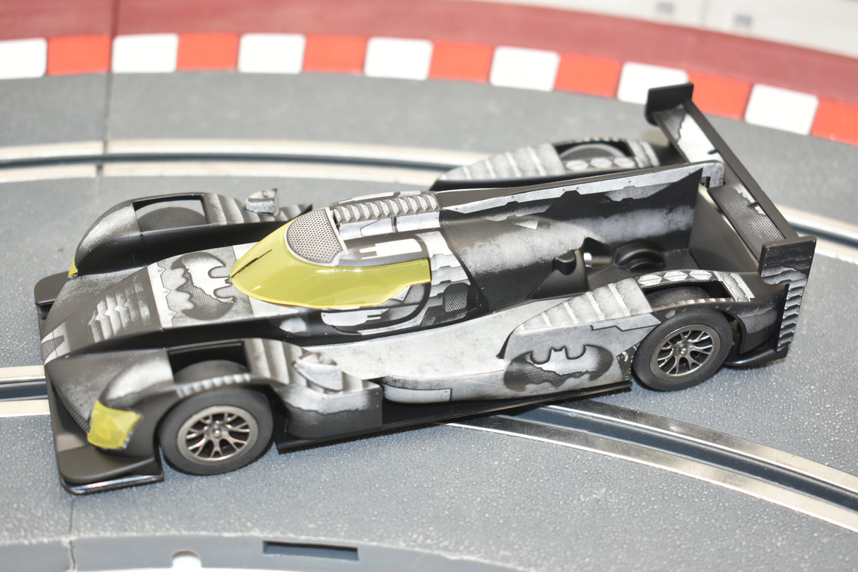 Black and yellow Batman car model on a track surface for Scalextric C4140