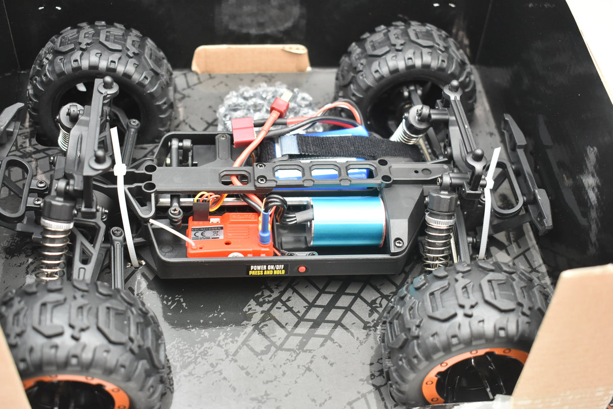 Monster truck electronics and tires laid out in a box for Blue/Yellow IMX19015