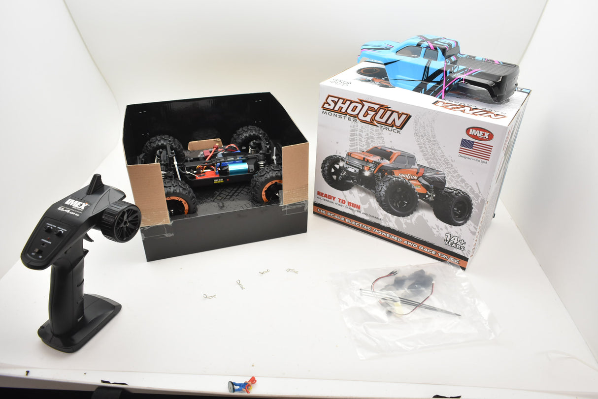 Remote control monster truck and accessories laid out on a white surface for Blue/Yellow IMX19015