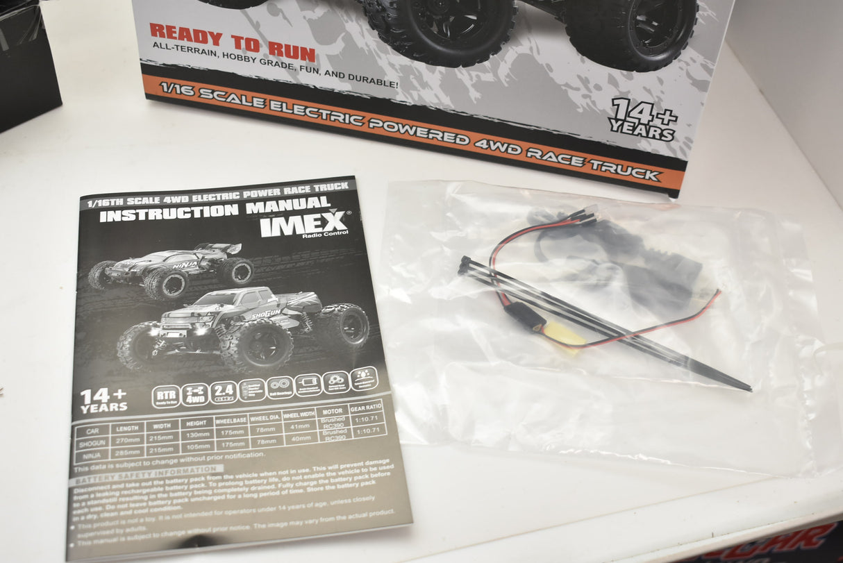 Remote-controlled monster truck with orange and green accents for ORANGE/GREEN IMX19025, rear view