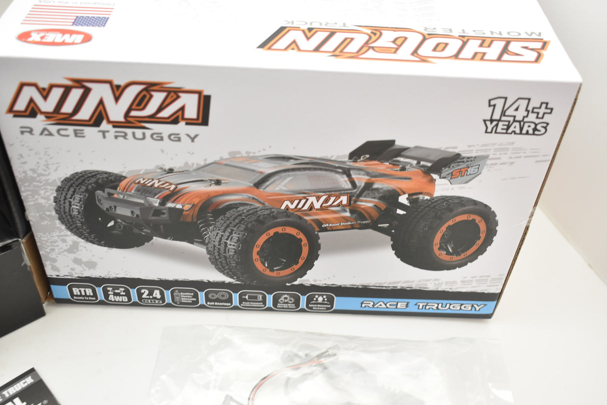 Orange and green remote-controlled monster truck on its box for ORANGE/GREEN IMX19025, package view, product view 30