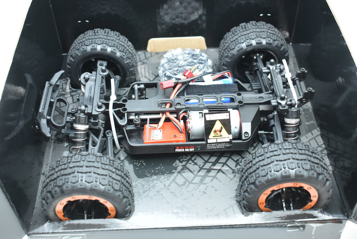 Orange and green monster truck on a black surface, ready to run for IMEX IMX19020