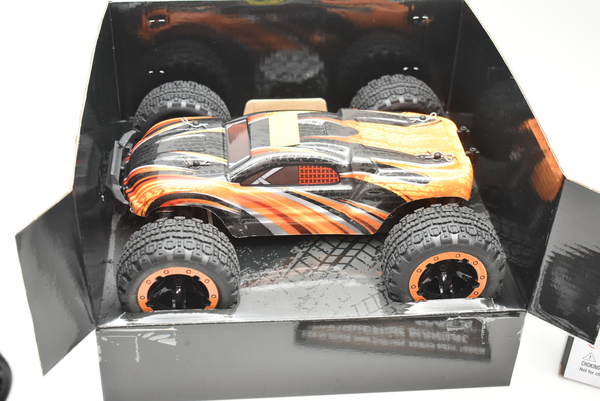Orange and black monster truck in its open box packaging for IMEX IMX19020
