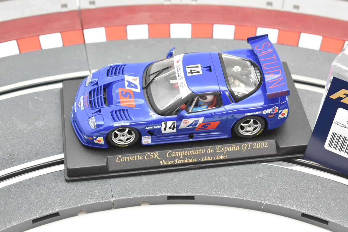 Blue race car model on a track base, labeled Corvette C5R 2002 for Fly Car A128
