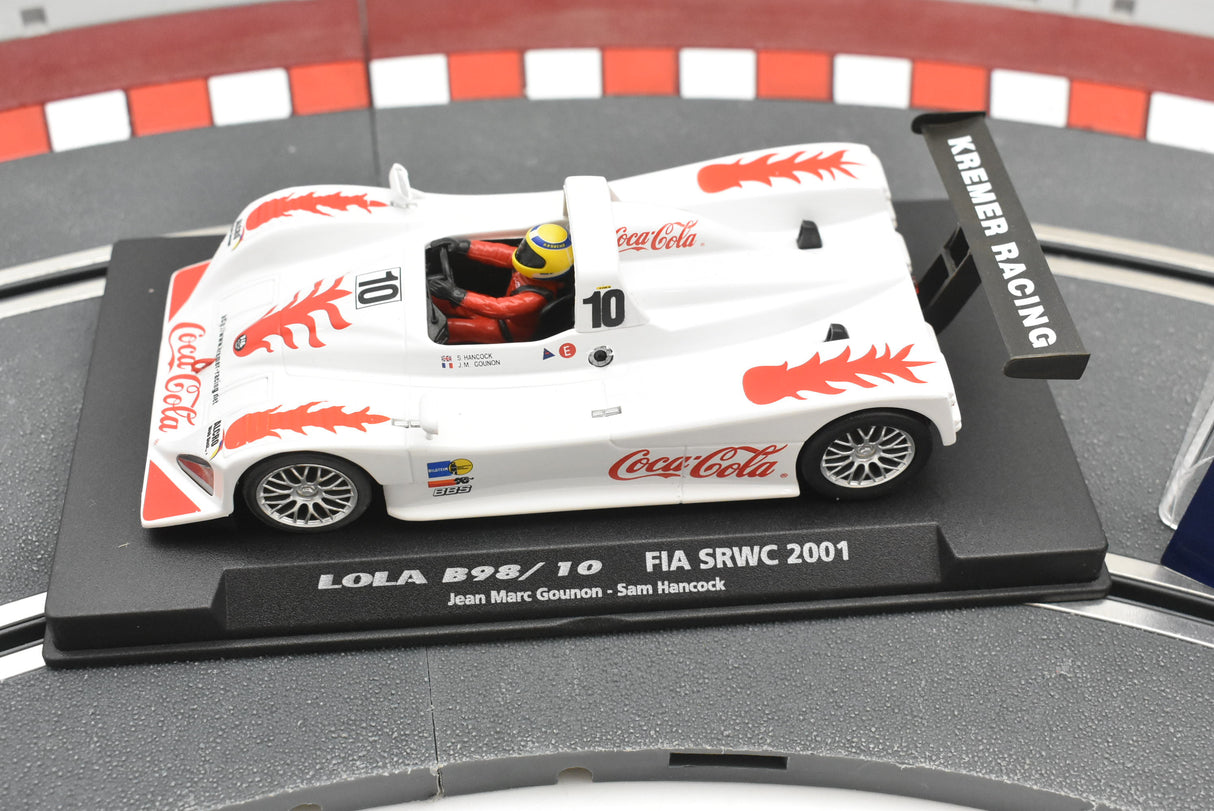 White race car model, Lola B98/10, with red Coca-Cola accents on a display base for Fly Car Fia Srwc 2001