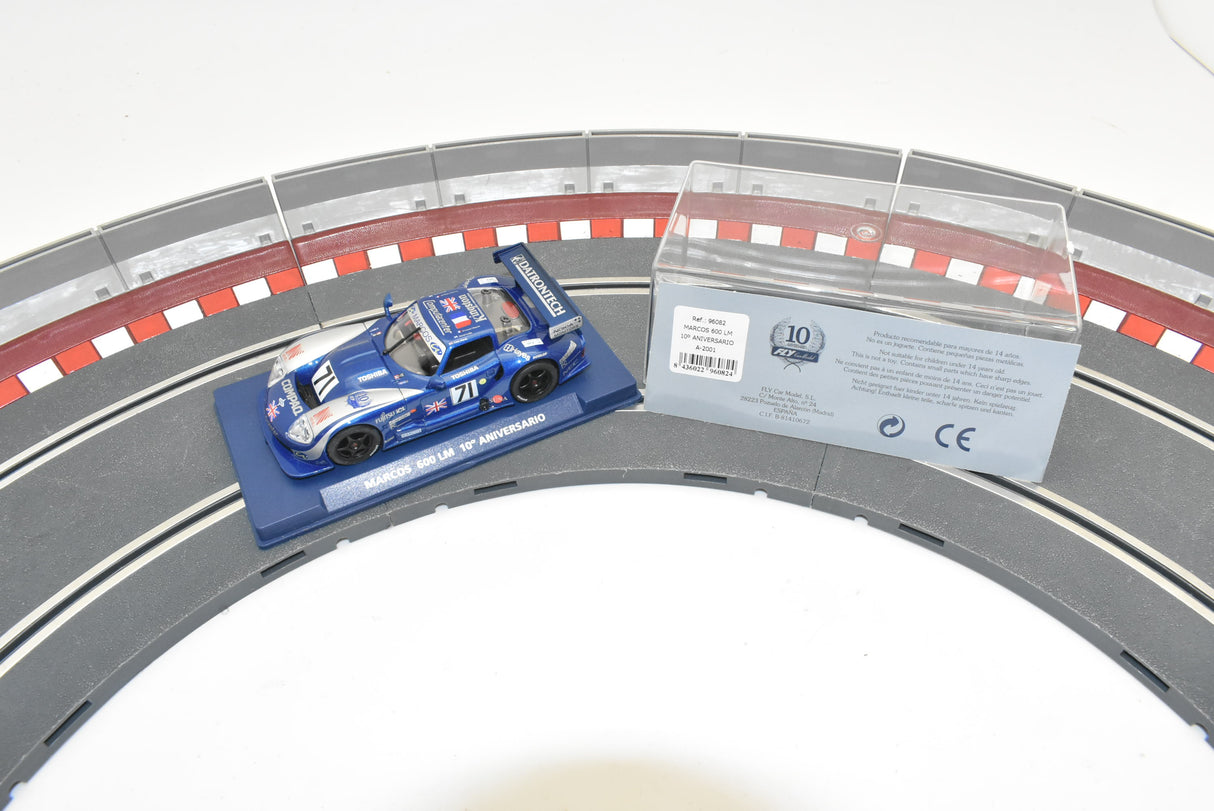 Blue race car on track with packaging showing 10th anniversary for Fly Car 10 Anicersario