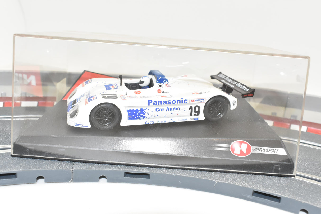 White race car model with "Panasonic" and "Car Audio" decals on a display base for Ninco 50201