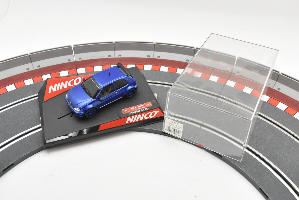 Blue slot car on a track with clear plastic piece for Ninco 50272