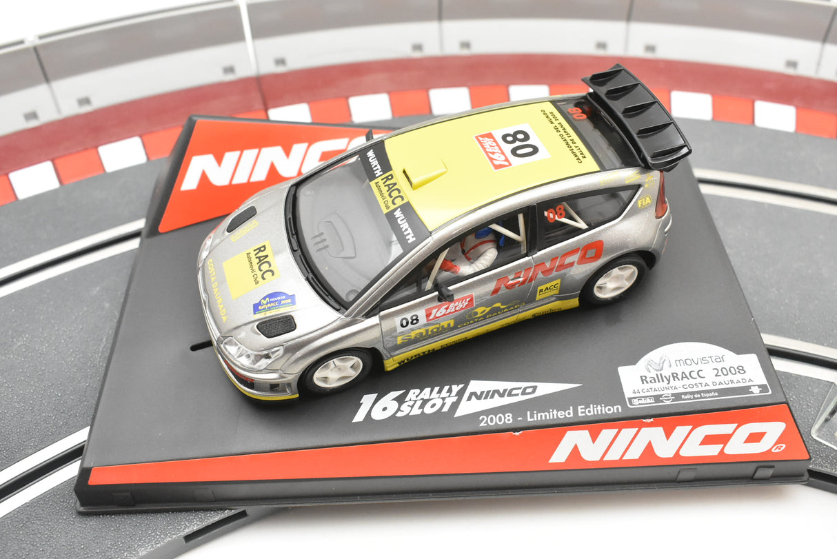 Slot car of a 2008 Citroen C4 WRC rally car on a display base for Ninco 50510