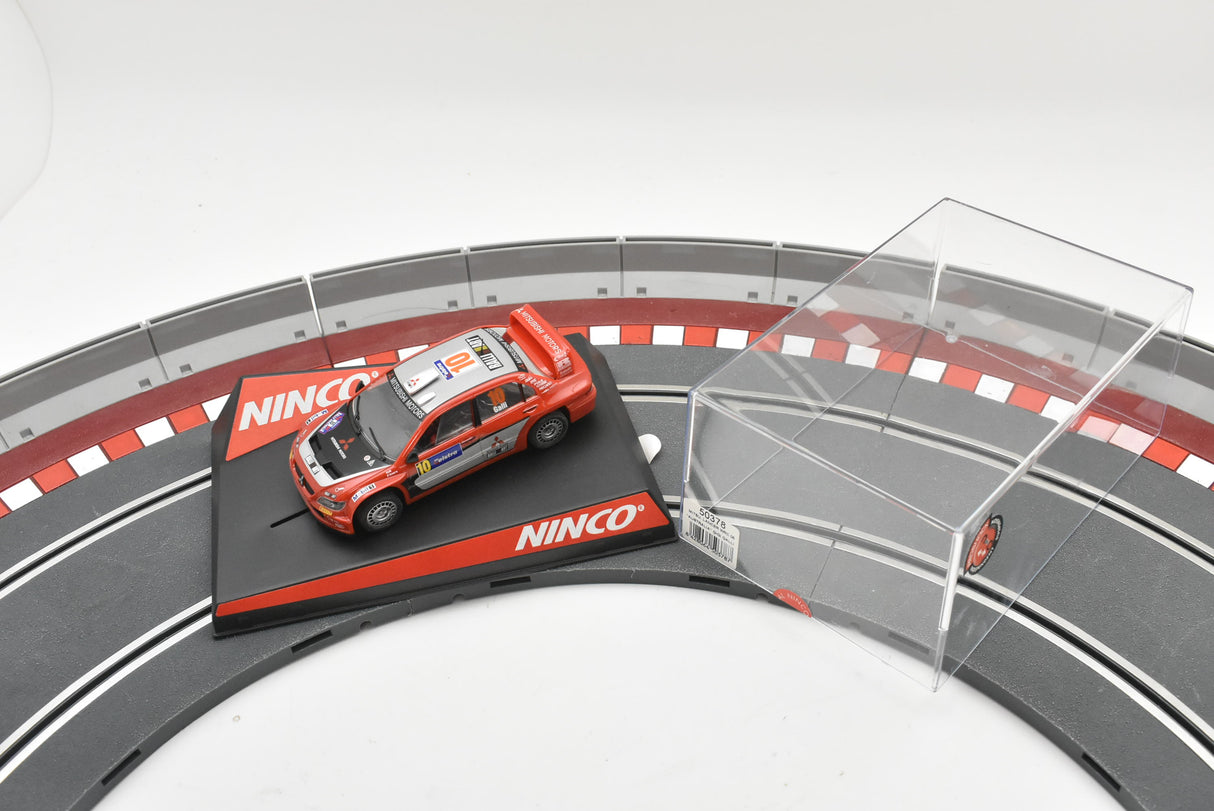 Red Mitsubishi Lancer WRC car on a track section for Ninco 50378