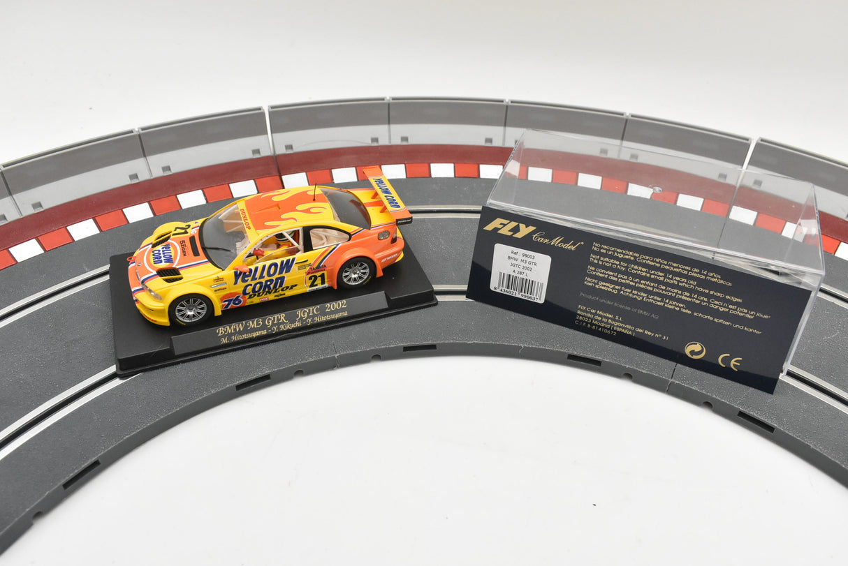 Yellow BMW M3 GTR race car on a track section with product info for Fly Car A287