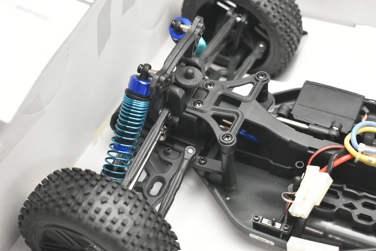 RC buggy chassis with suspension springs and wheels visible for IMEX 18020